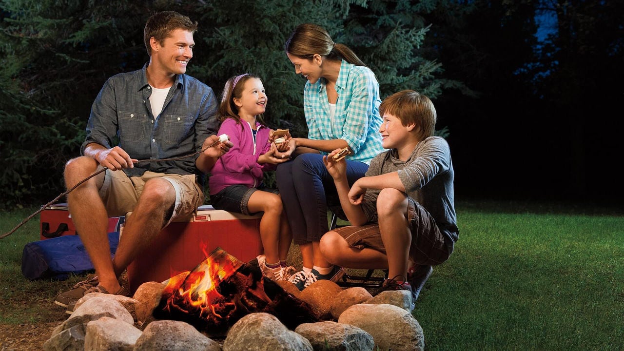 family sitting around campfire