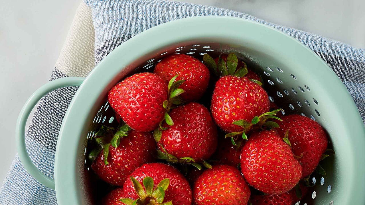 strainer filled with fresh strawberries