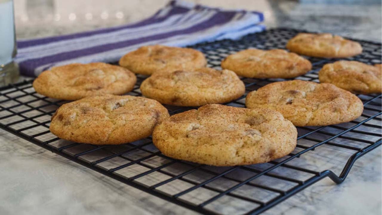 fresh batch of cinnamon chip snickerdoodle cookies cooling on wire rack