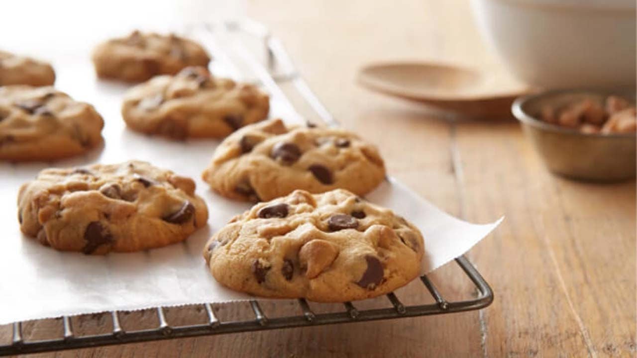 fresh batch of double peanut butter and milk chocolate chip cookies cooling on wire rack