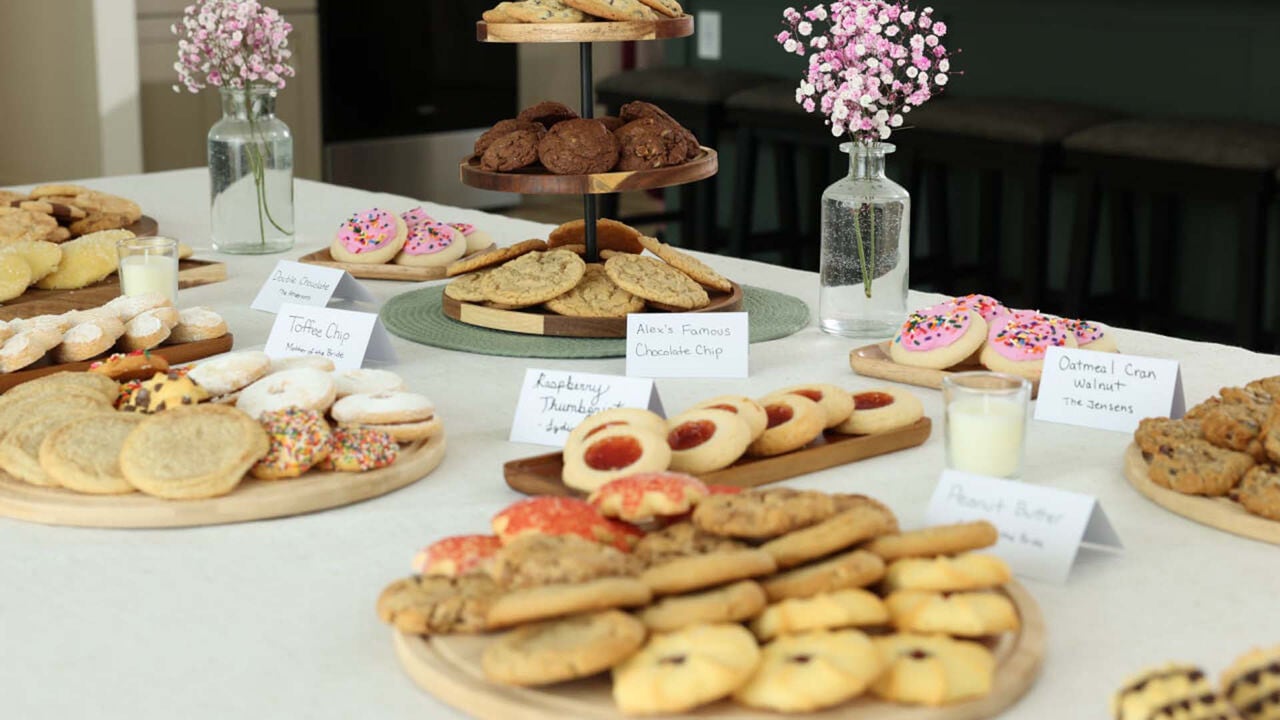 table topped with an assortment of plated cookies paired with flavor labels