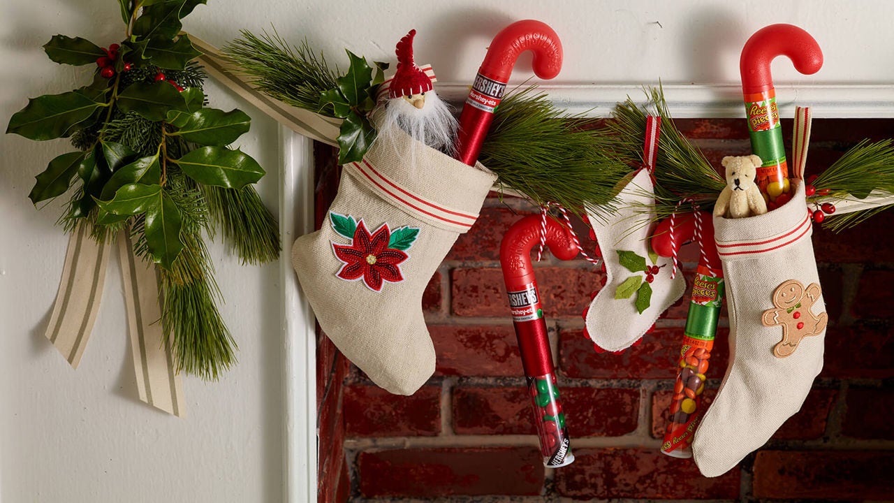 full stockings hanging in front of fireplace