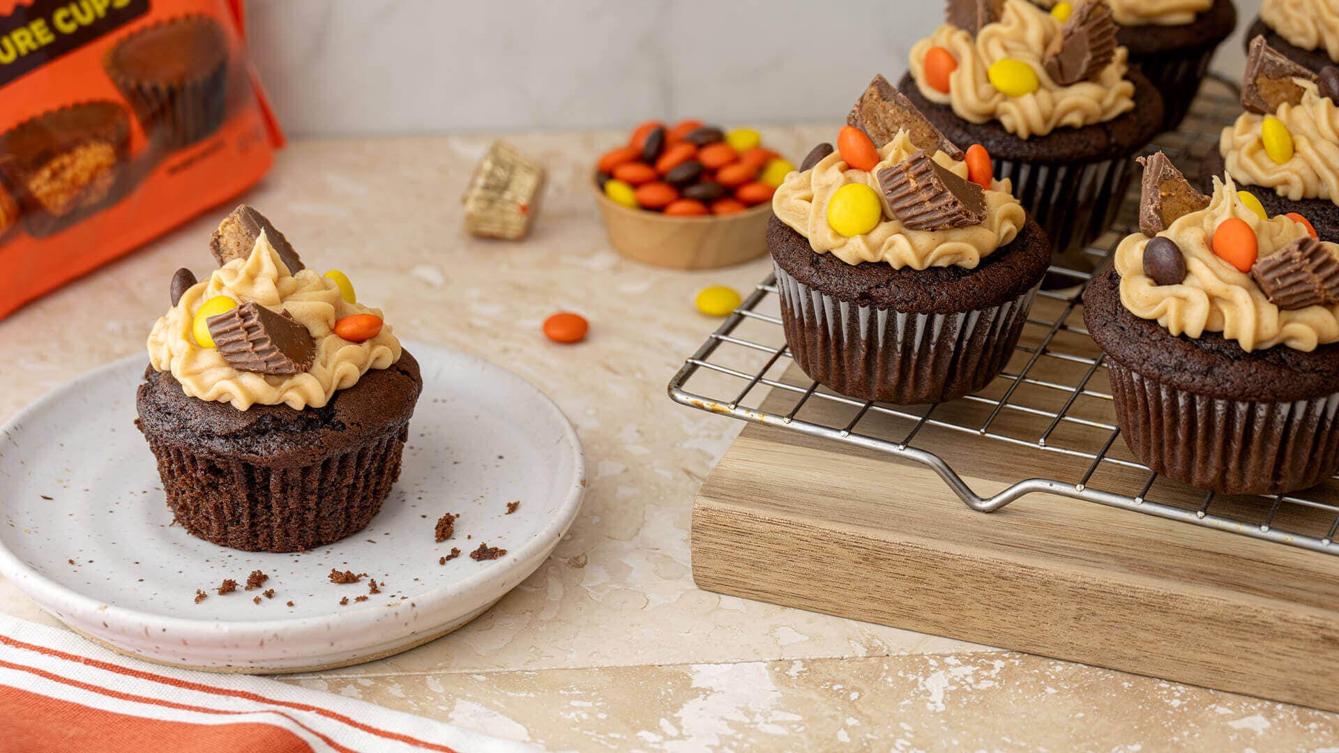 freshly baked reeses peanut butter and chocolate cupcakes on cooling rack
