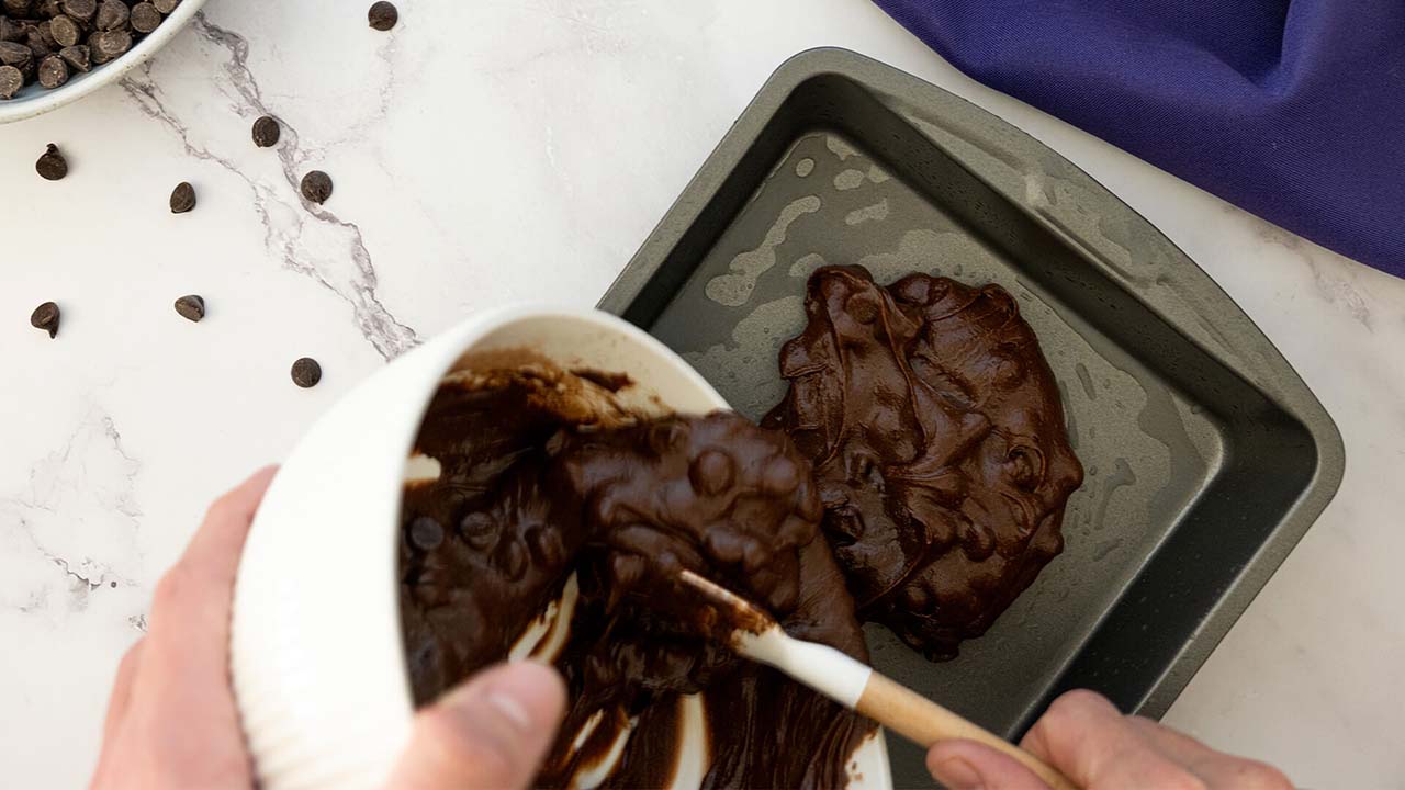 pouring batter into the greased baking pan