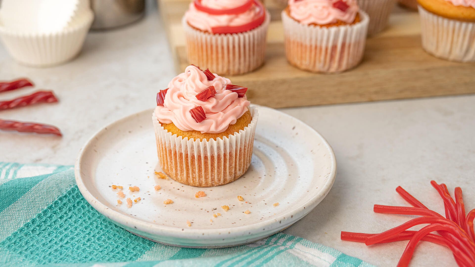 twizzlers strawberry cupcakes decorated in different designs using twizzlers candy