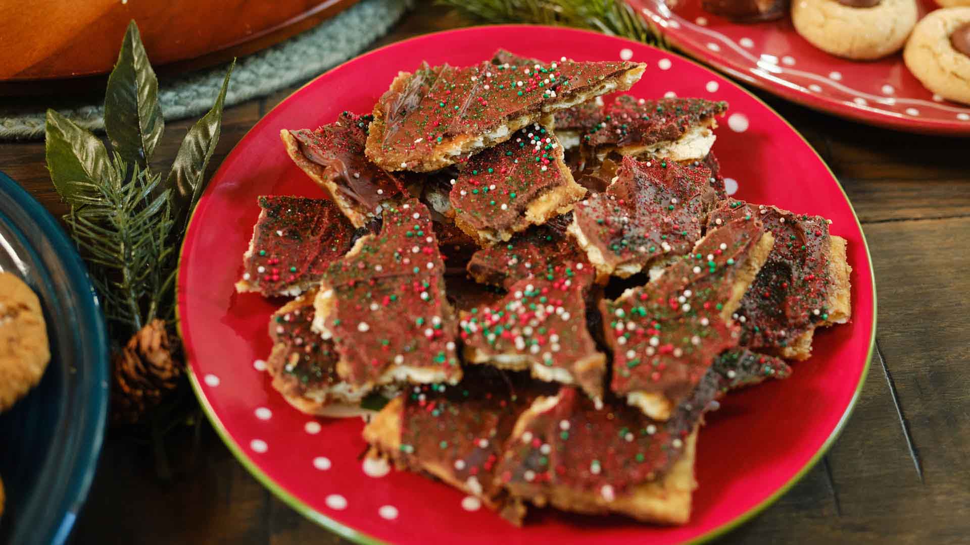 plate of hersheys christmas bark beside other baked goods