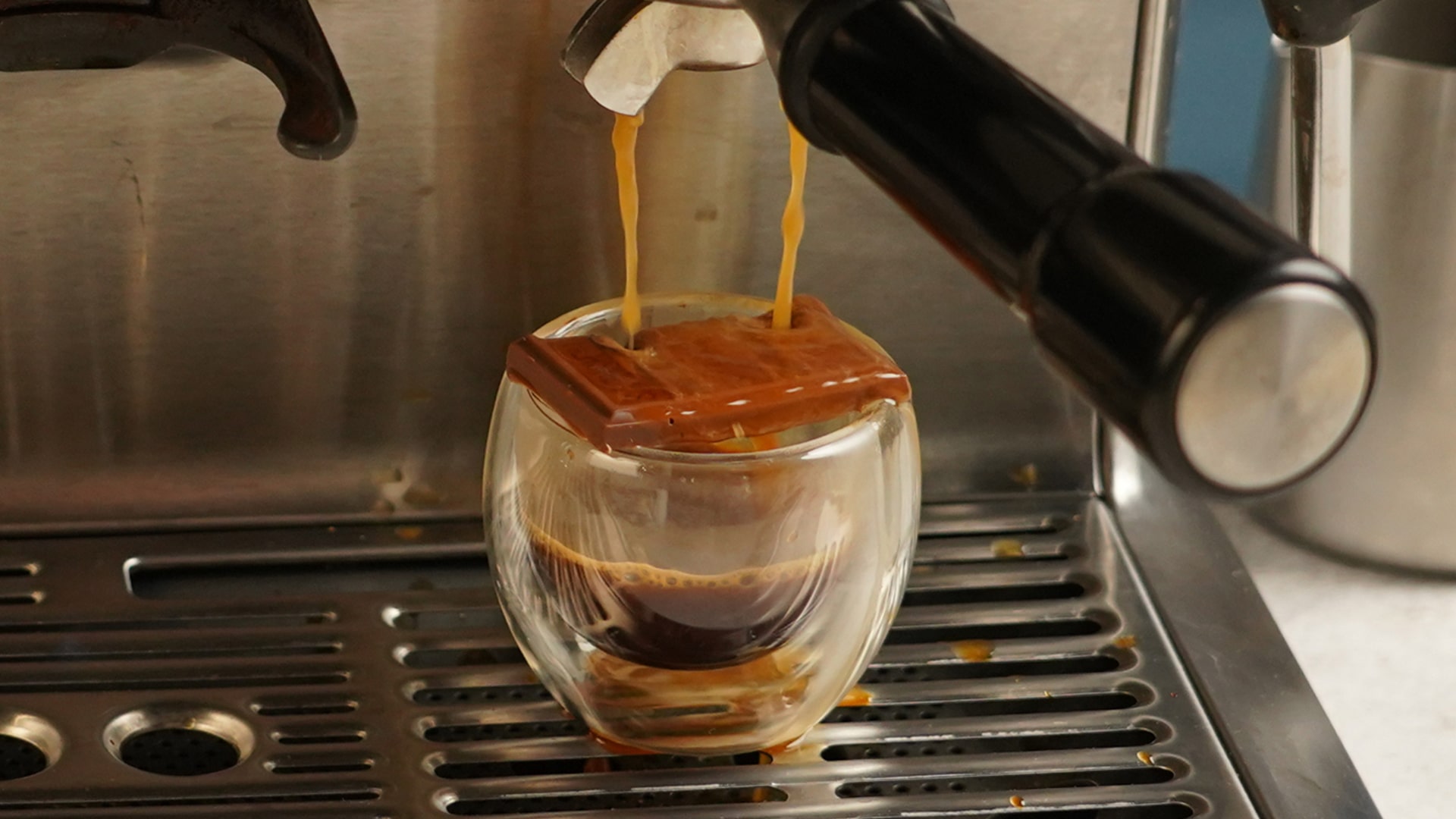 espresso being poured over chocolate bar