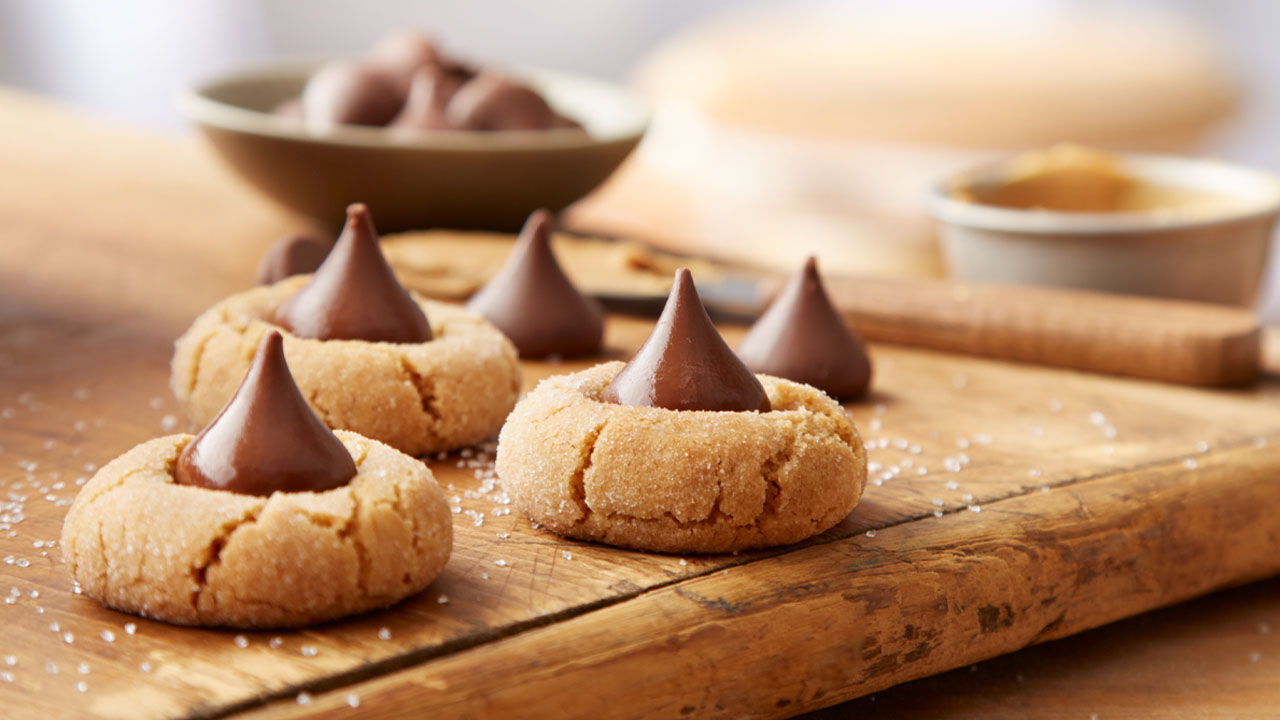 peanut butter blossom cookies on wooden cutting board