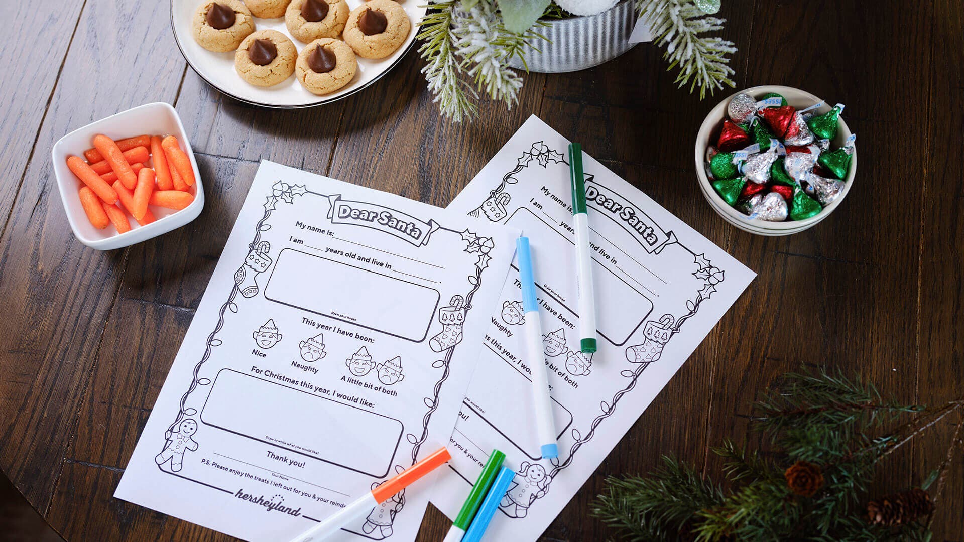 letter to santa printouts next to bowls of hershey holiday treats