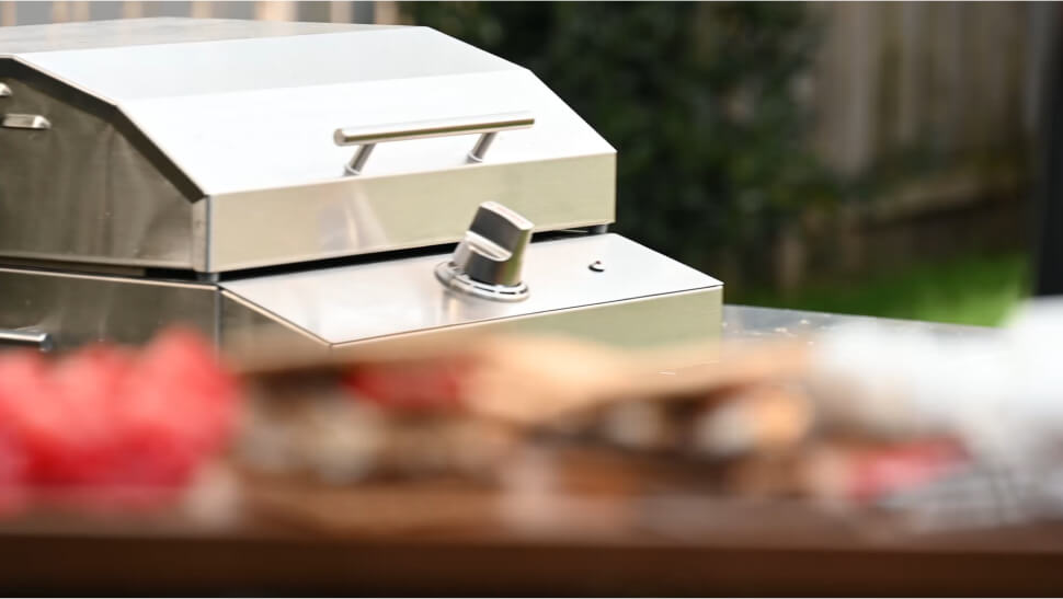 person breaking a classic flavored grilled smore with strawberries in half