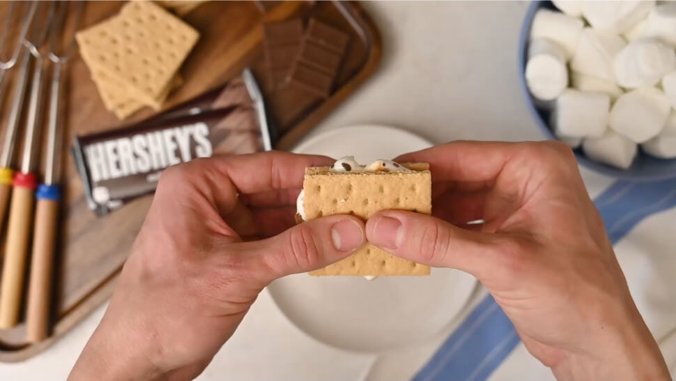 person breaking a classic flavored stovetop smore in half