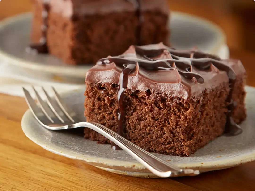 square chocolate cake slices on serving plates